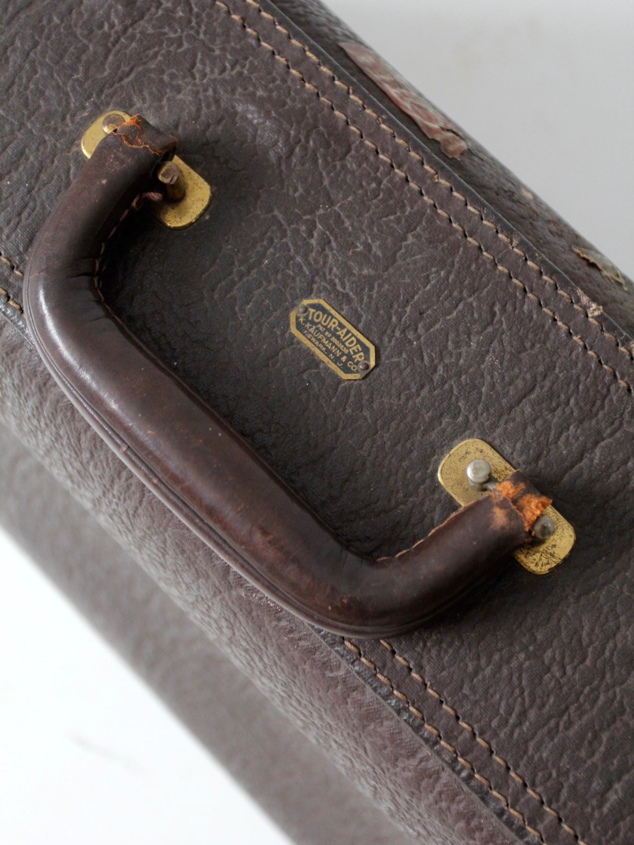 vintage leather suitcase with travel stickers