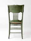 antique green pressed back chair with perforated seat
