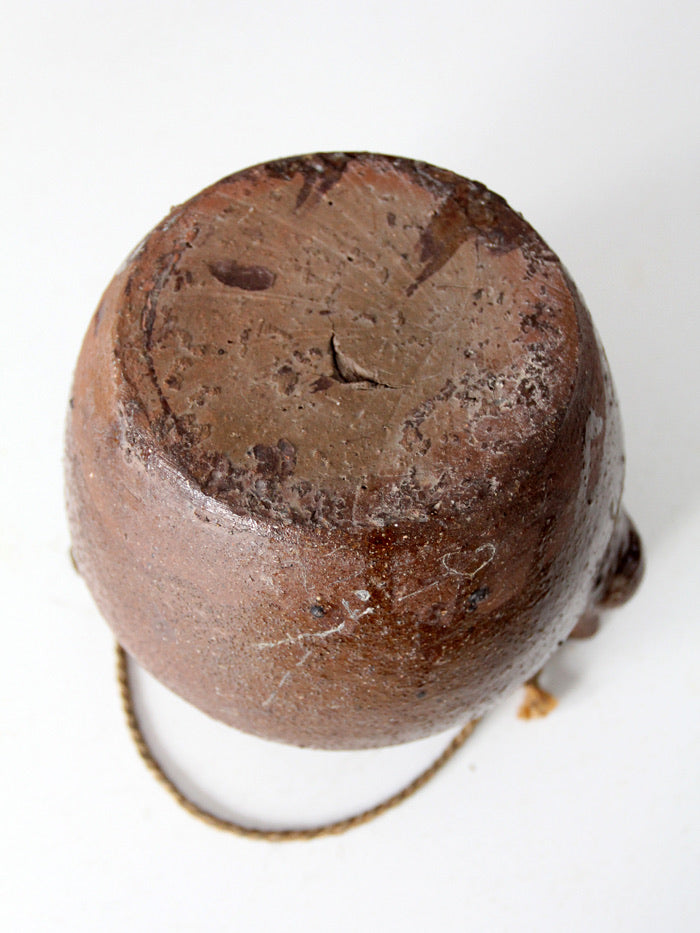 antique earthenware water pot with rope handle