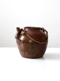 antique earthenware water pot with rope handle