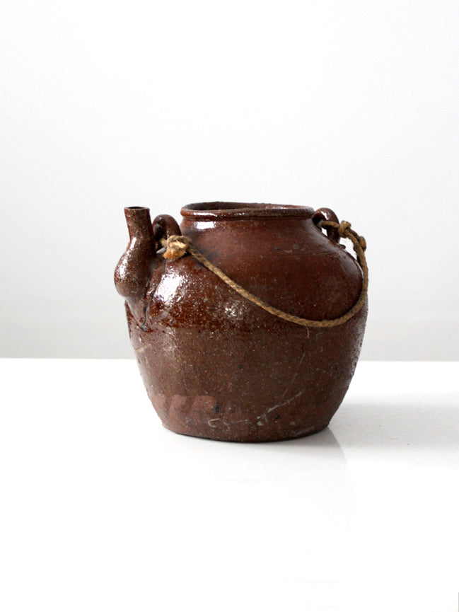 antique earthenware water pot with rope handle