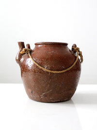 antique earthenware water pot with rope handle