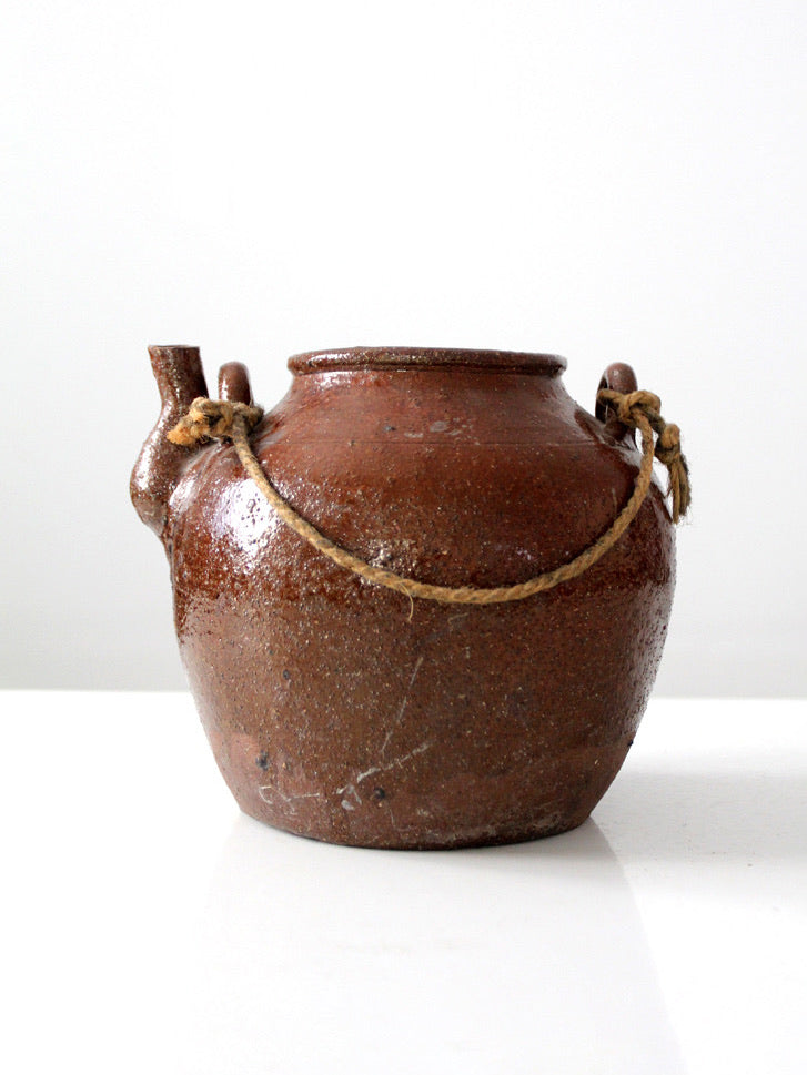 antique earthenware water pot with rope handle