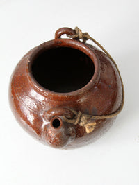 antique earthenware water pot with rope handle
