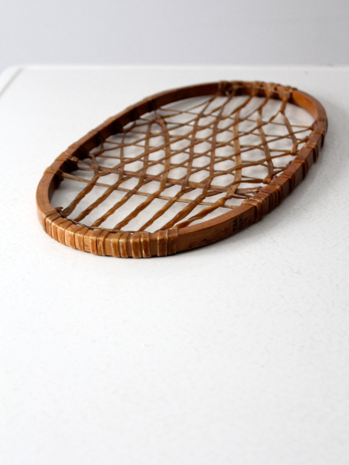 1940s Lund wooden snowshoe with rawhide webbing
