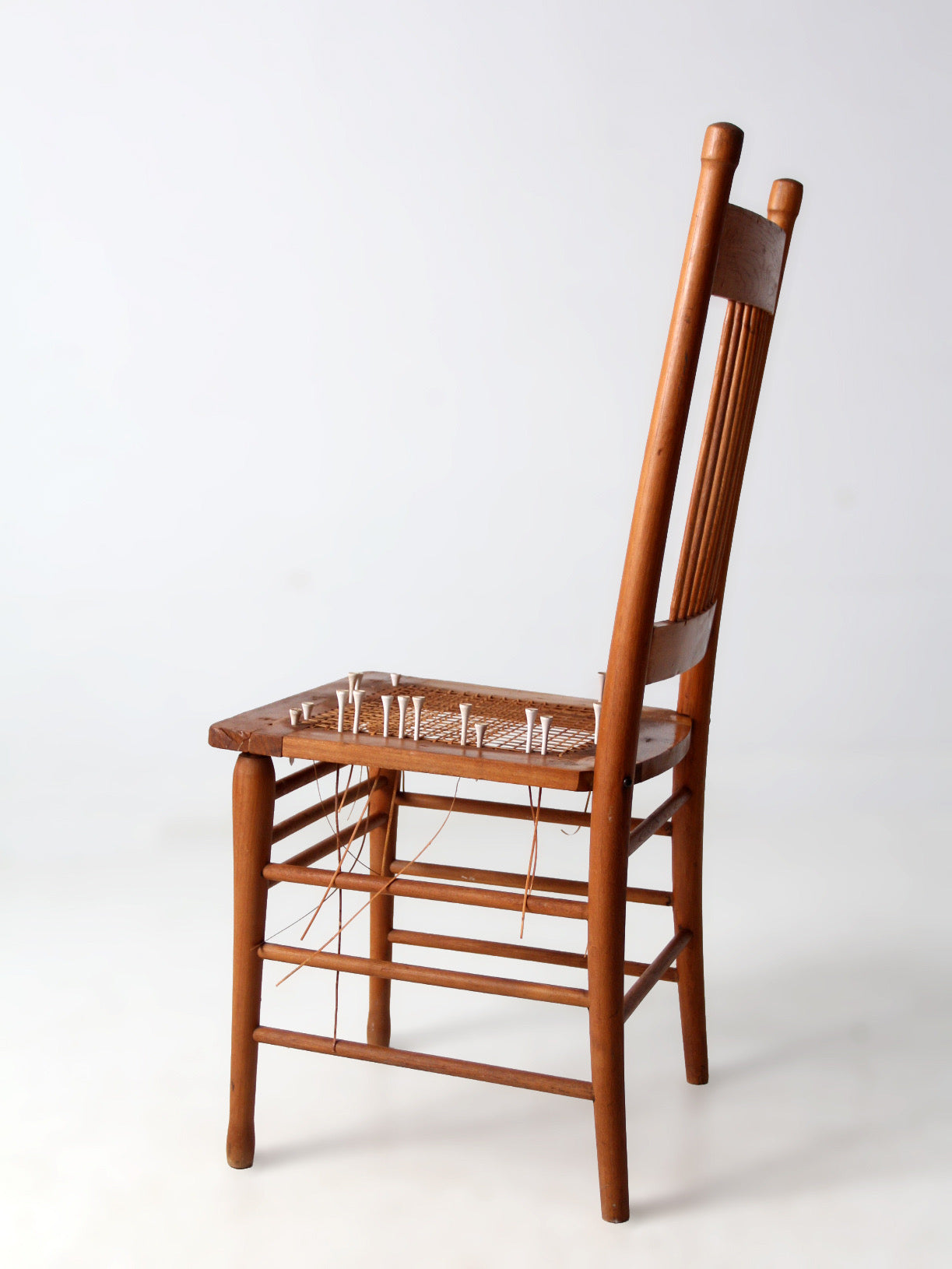 antique spindle back chair art installation | early American form