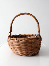 vintage woven gathering basket with bamboo handle