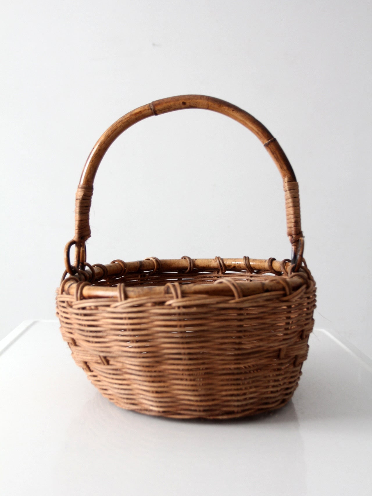 vintage woven gathering basket with bamboo handle