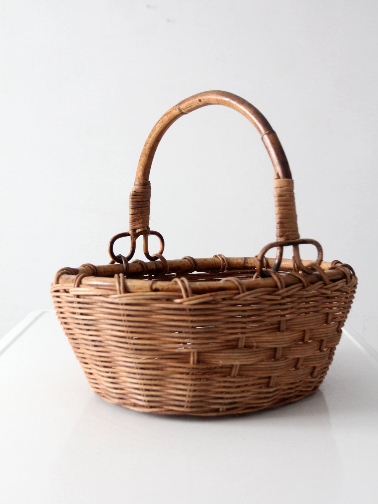 vintage woven gathering basket with bamboo handle