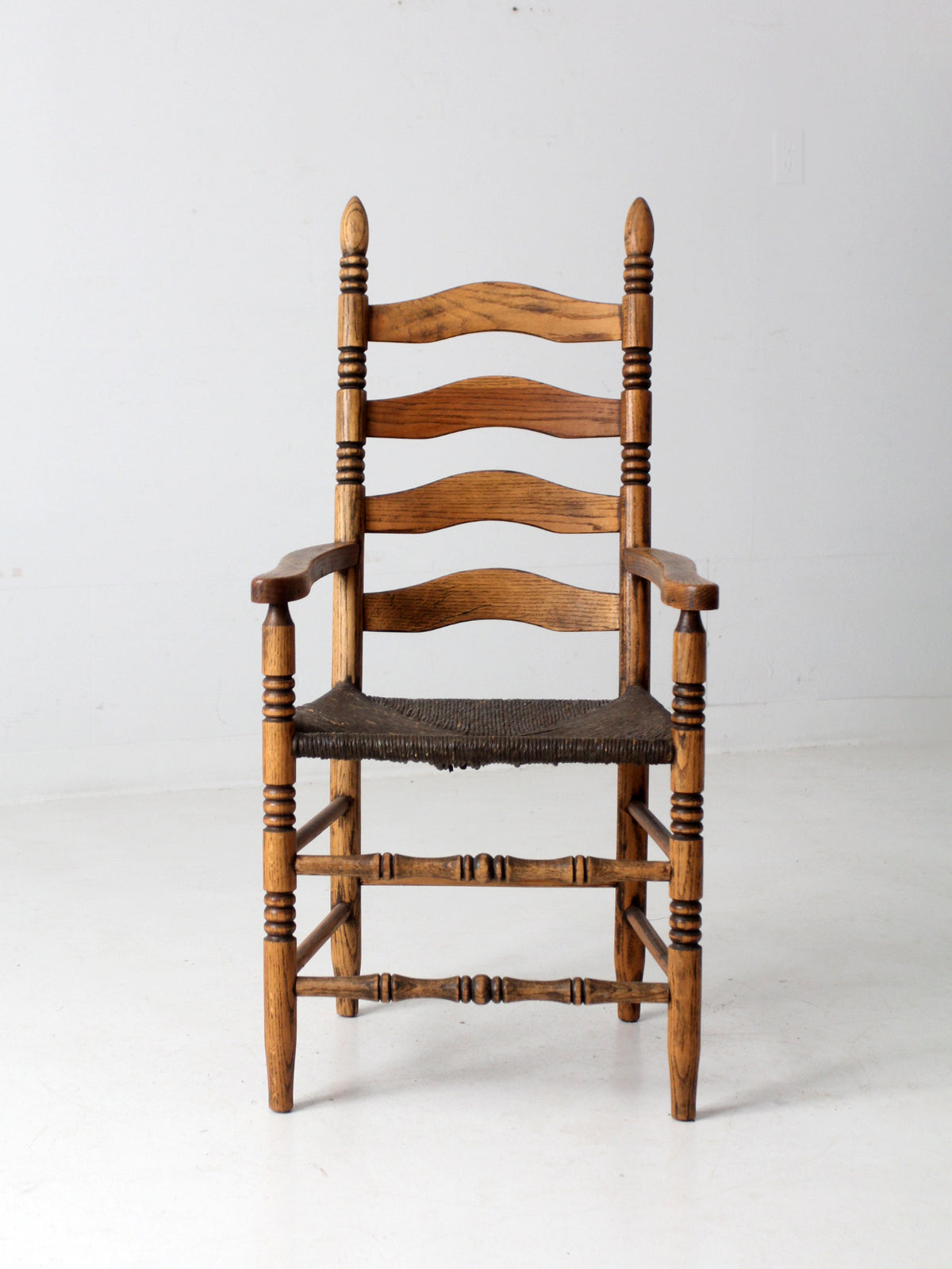 antique rush seat ladder back arm chair