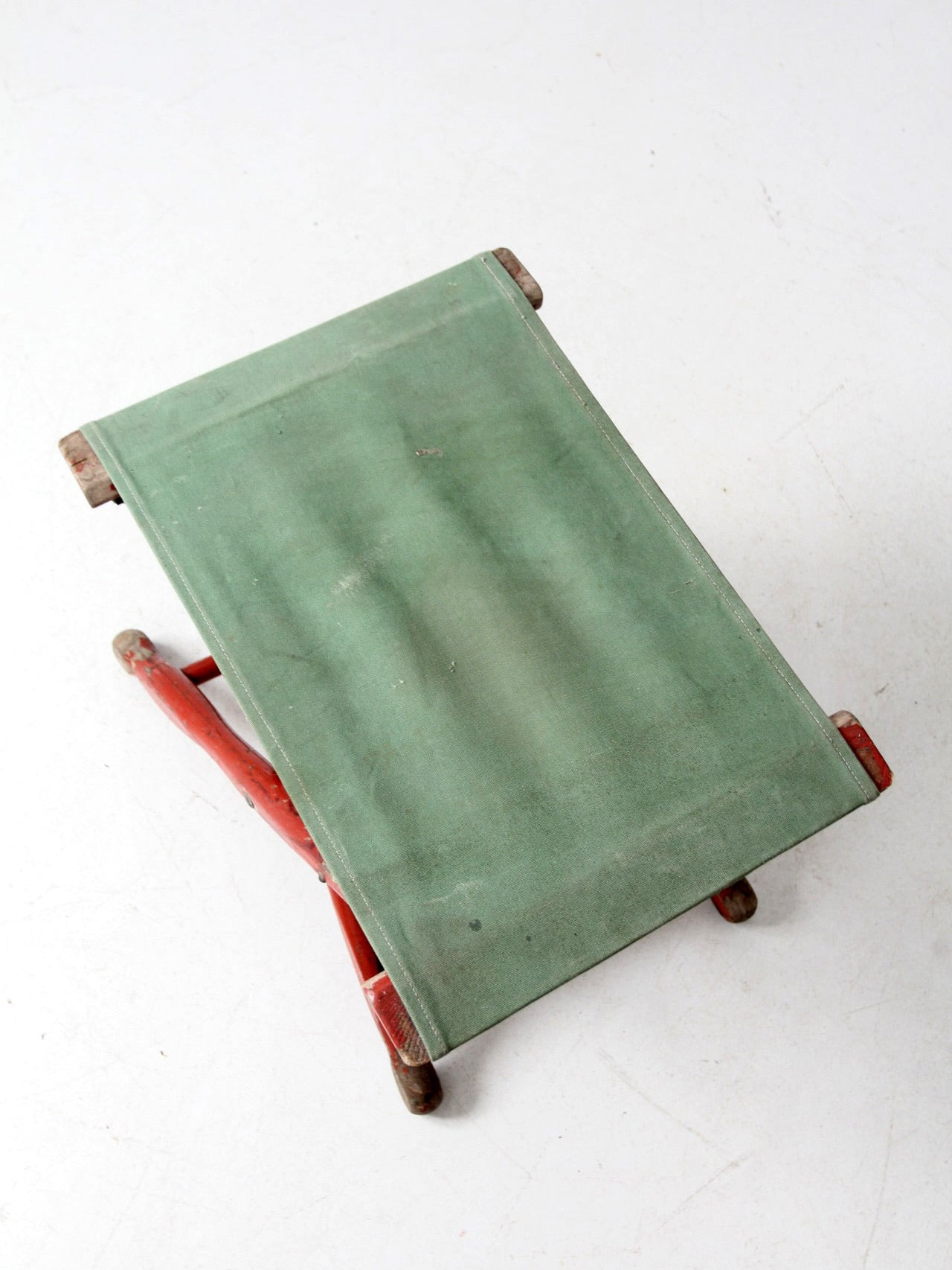 vintage red and green x-frame camp stool