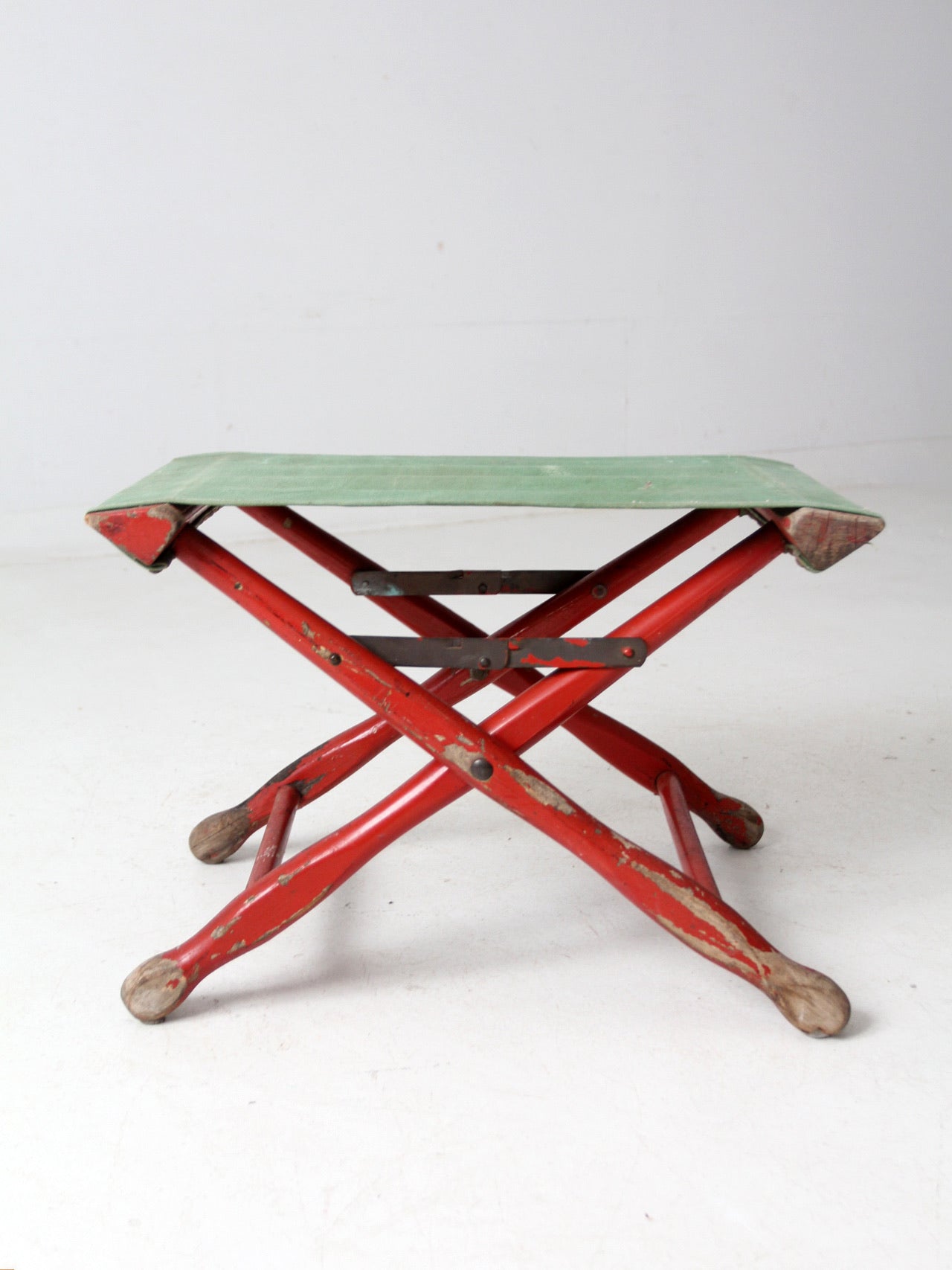 vintage red and green x-frame camp stool