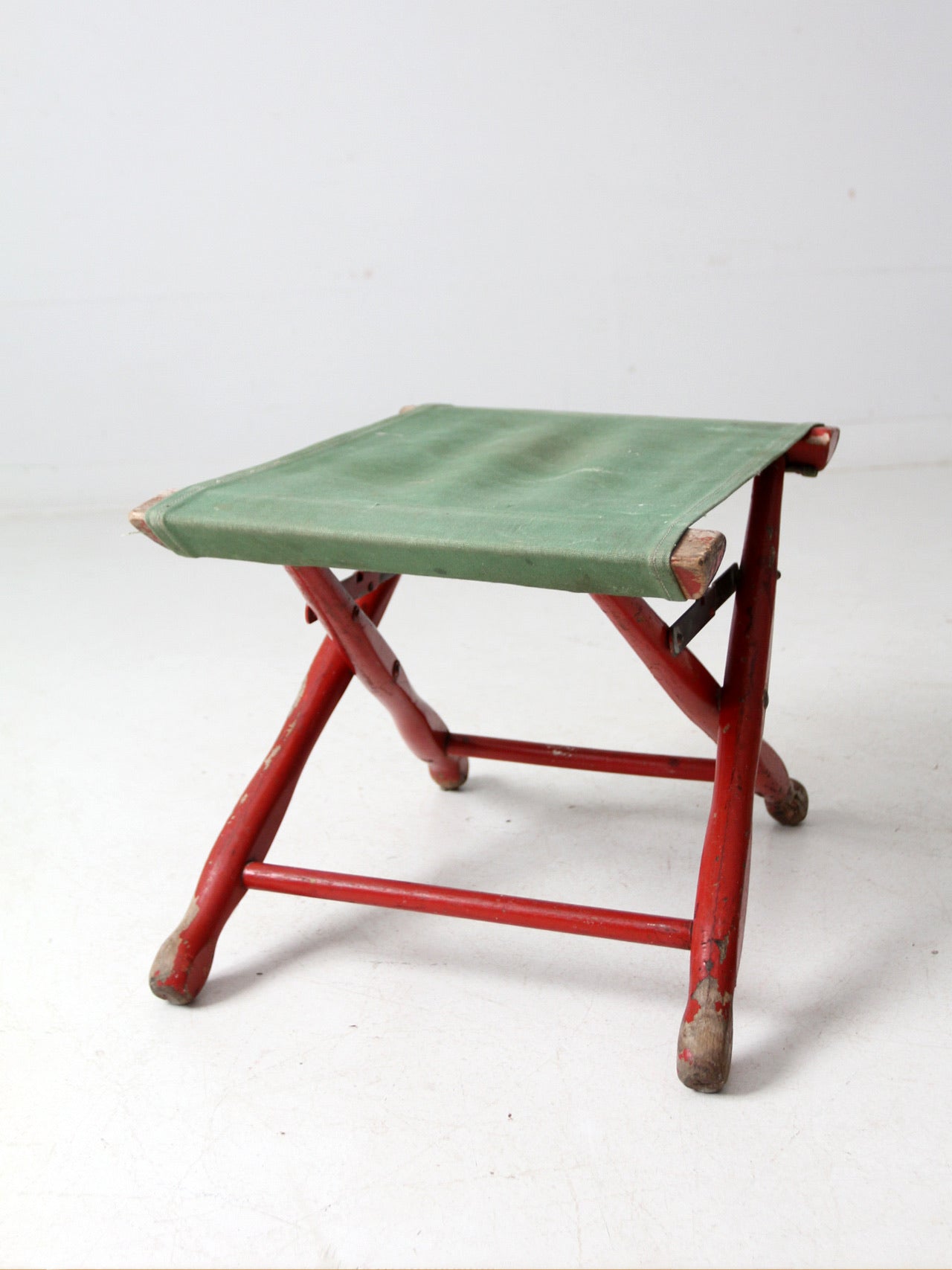 vintage red and green x-frame camp stool