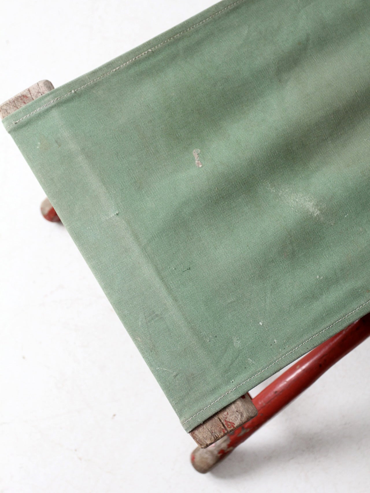 vintage red and green x-frame camp stool