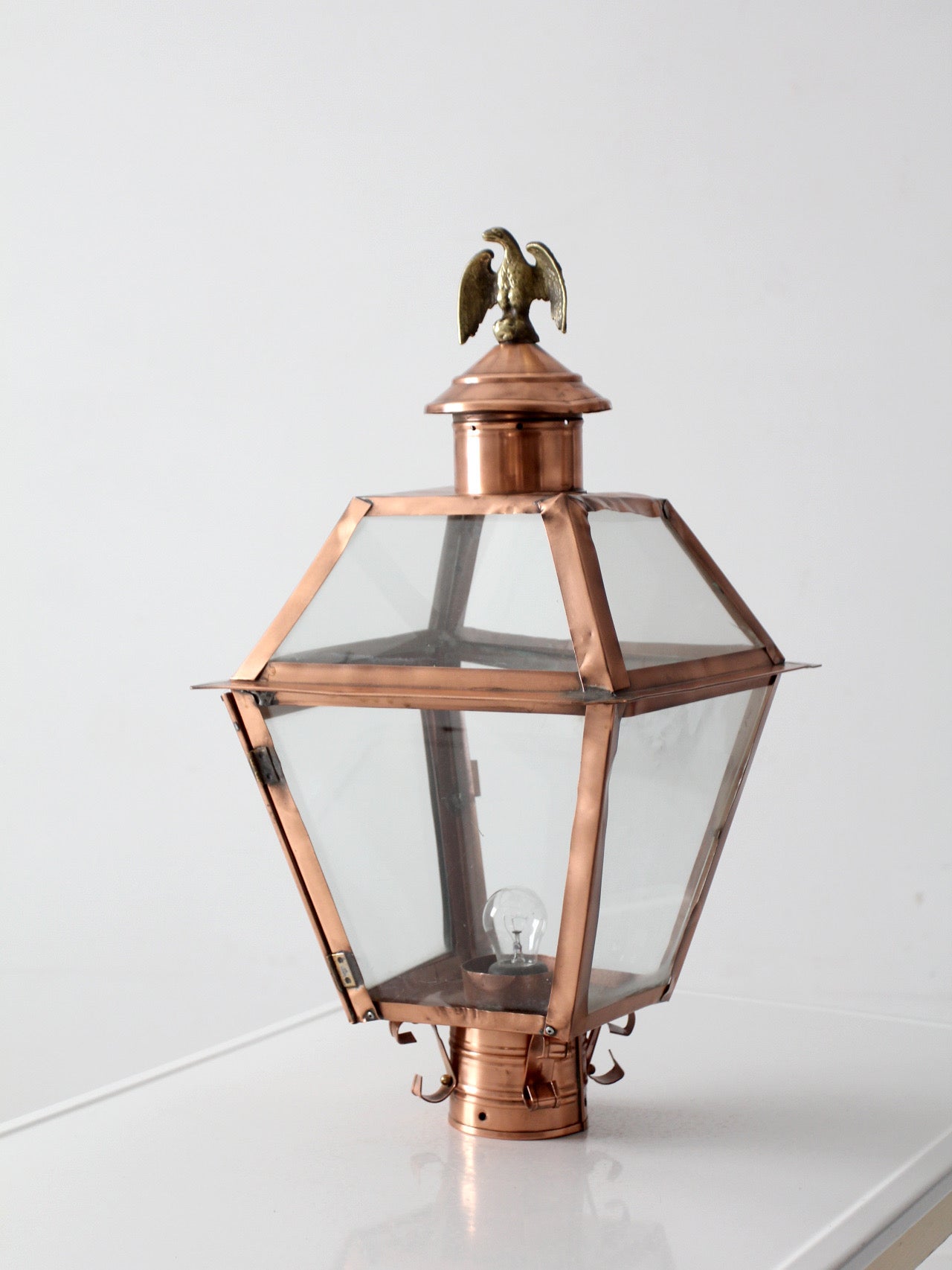 vintage copper lantern light fixture with brass eagle finial