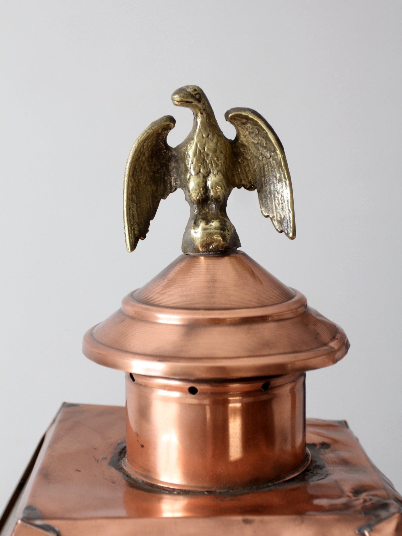vintage copper lantern light fixture with brass eagle finial