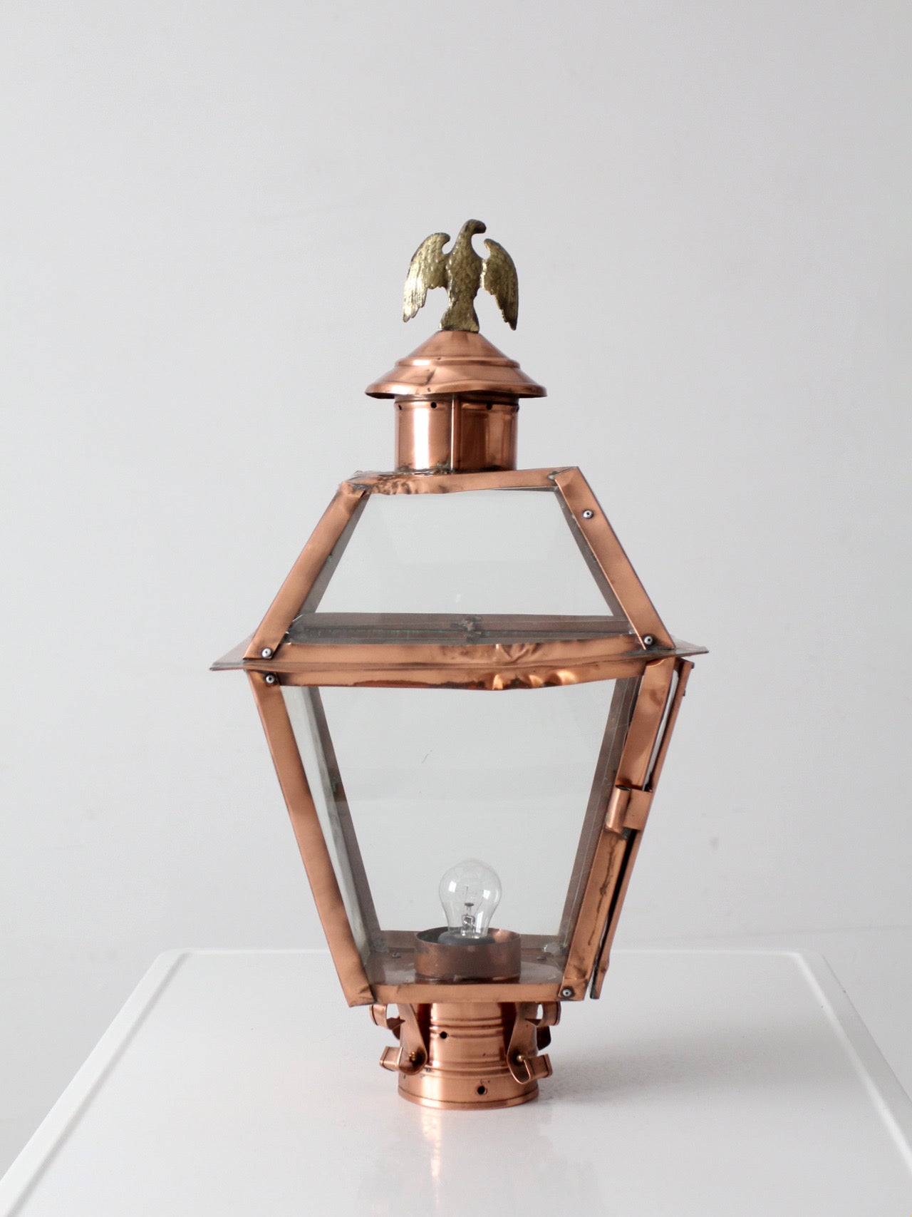 vintage copper lantern light fixture with brass eagle finial