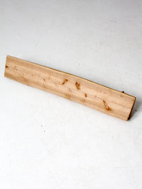 vintage hand-carved pine wall rack with peg hooks