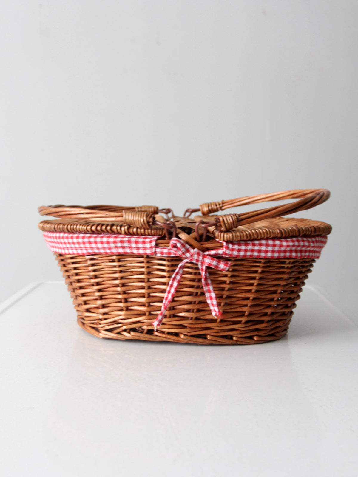 vintage wicker picnic basket with gingham lining