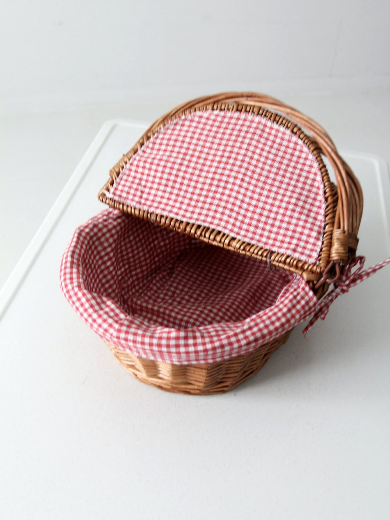 vintage wicker picnic basket with gingham lining