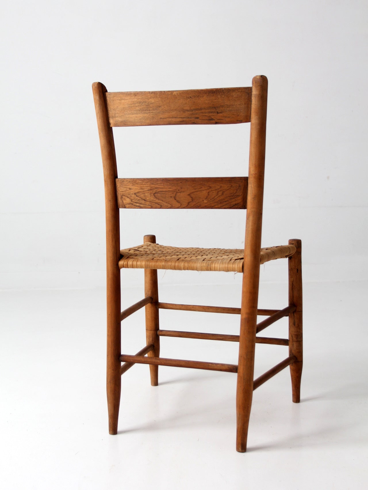 antique ladder back chair with woven splint seat