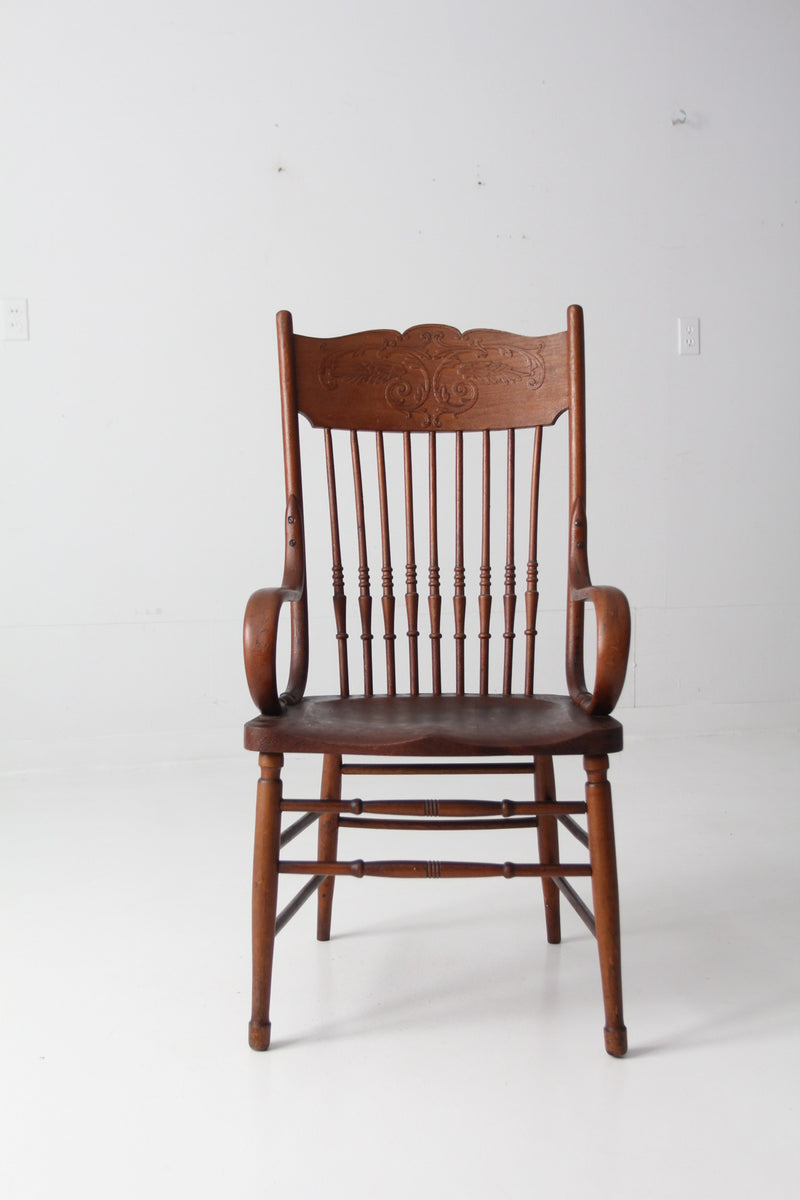 antique pressed back arm chair