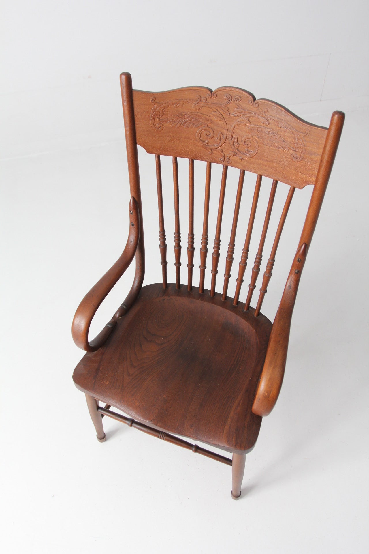 antique pressed back arm chair