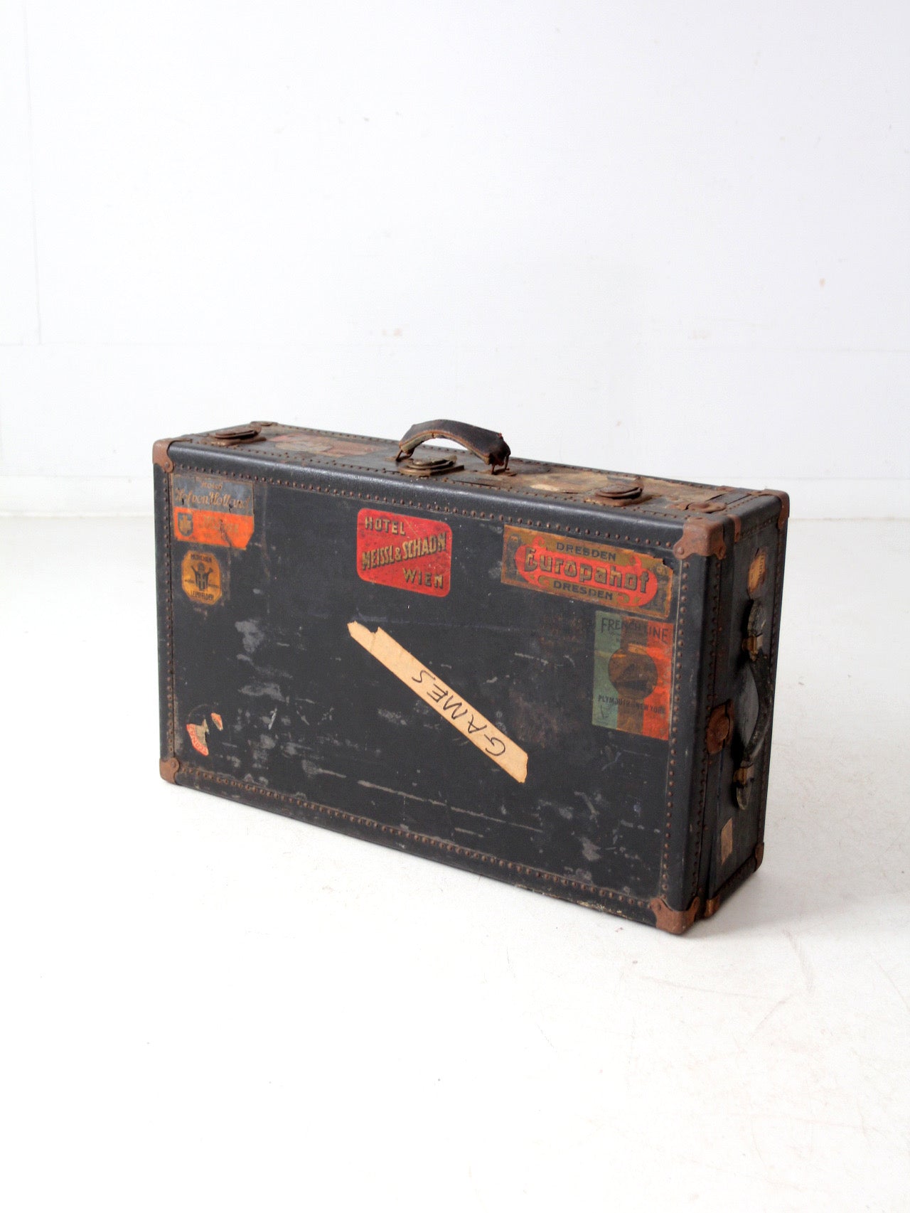 antique leather suitcase with European hotel labels, early 20th century