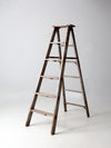 vintage wooden ladder with metal braces