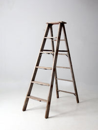 vintage wooden ladder with metal braces