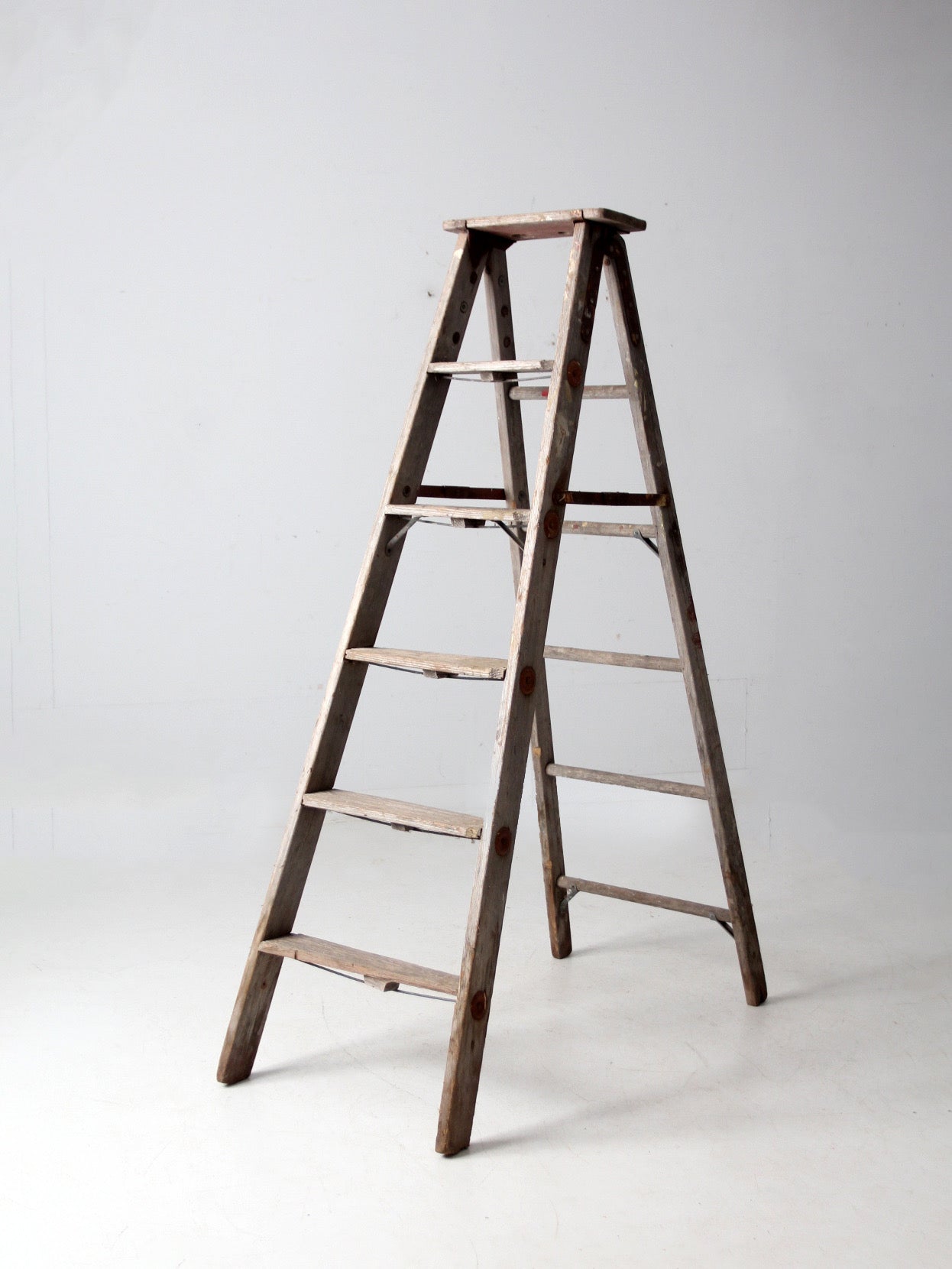 vintage wooden ladder with metal braces