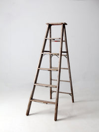 vintage wooden ladder with metal braces