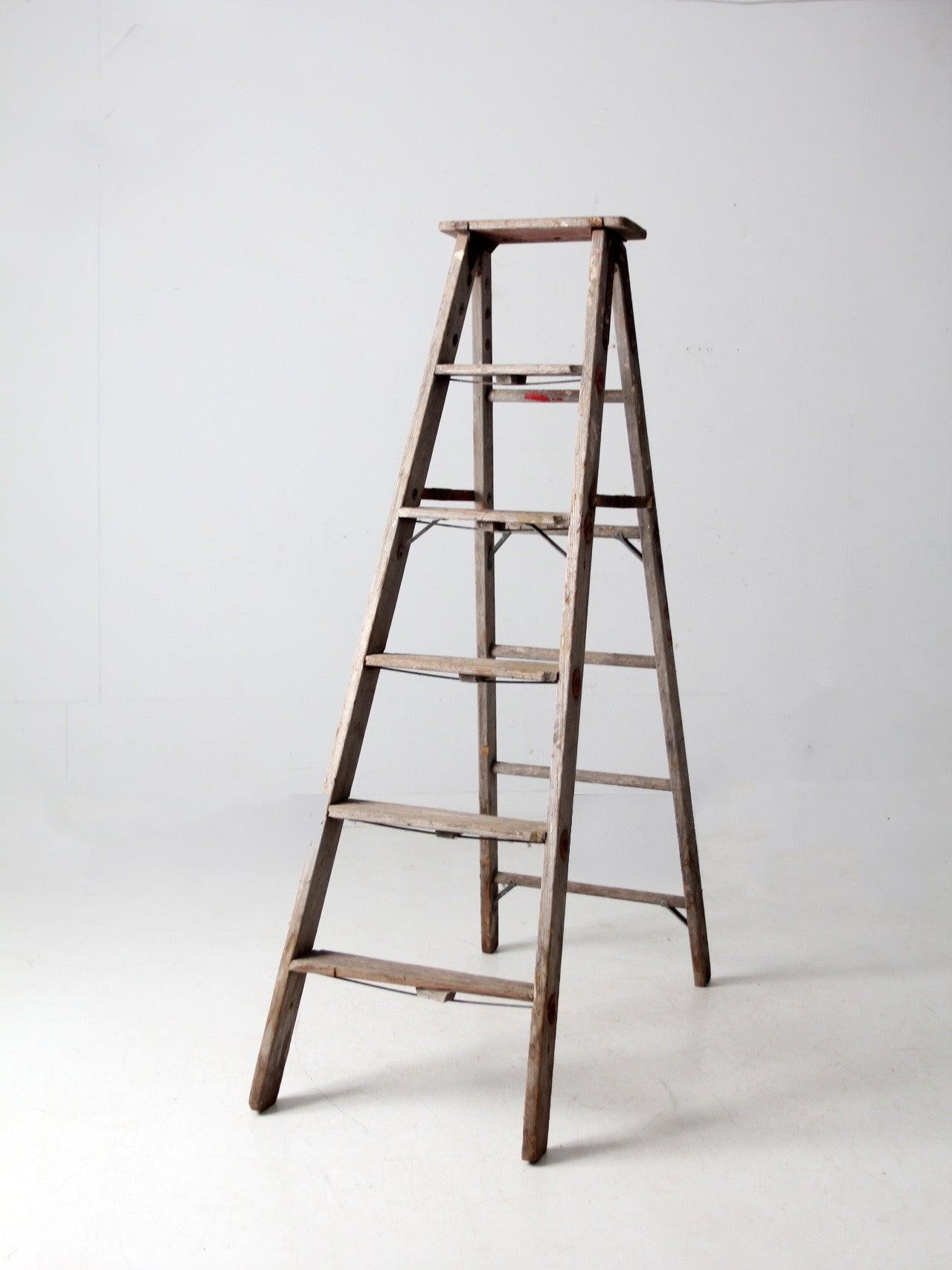 vintage wooden ladder with metal braces