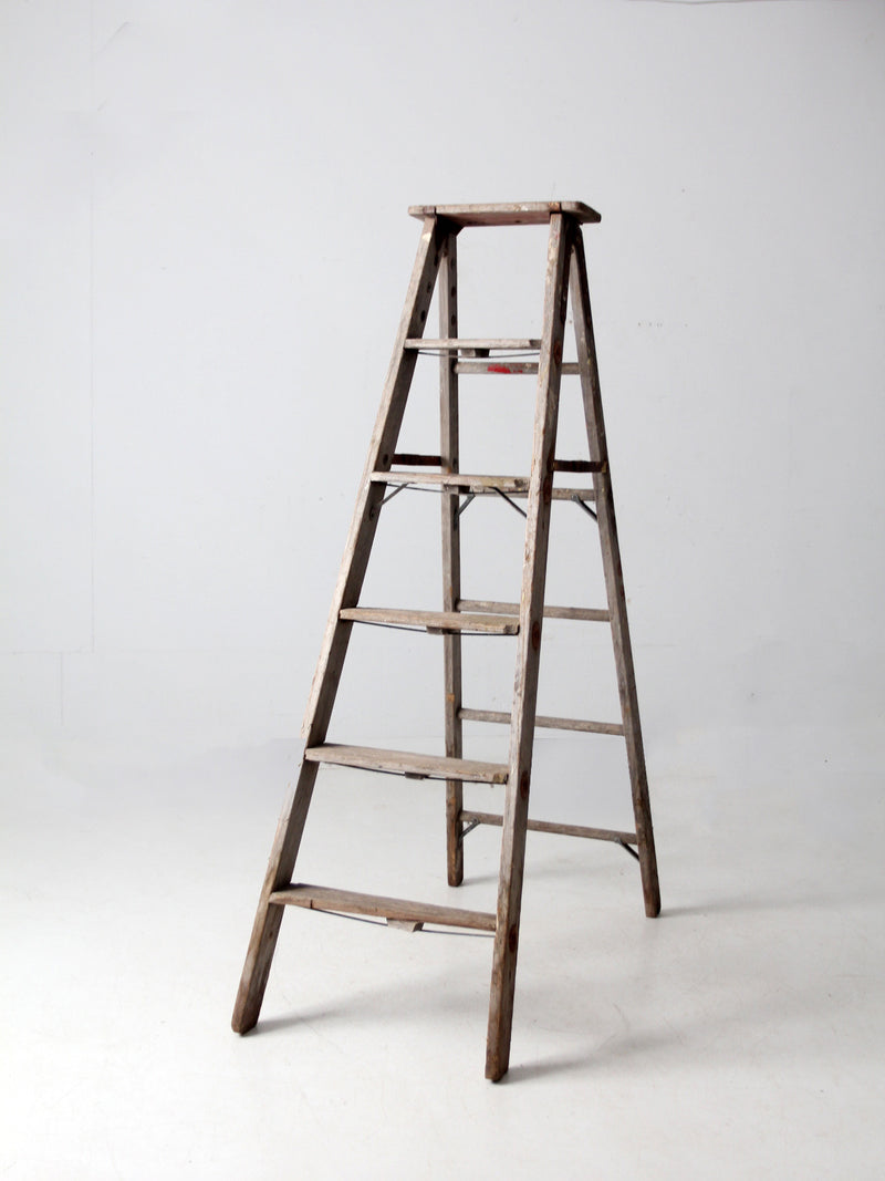 vintage wooden ladder with metal braces