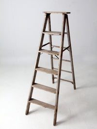 vintage wooden ladder with metal braces