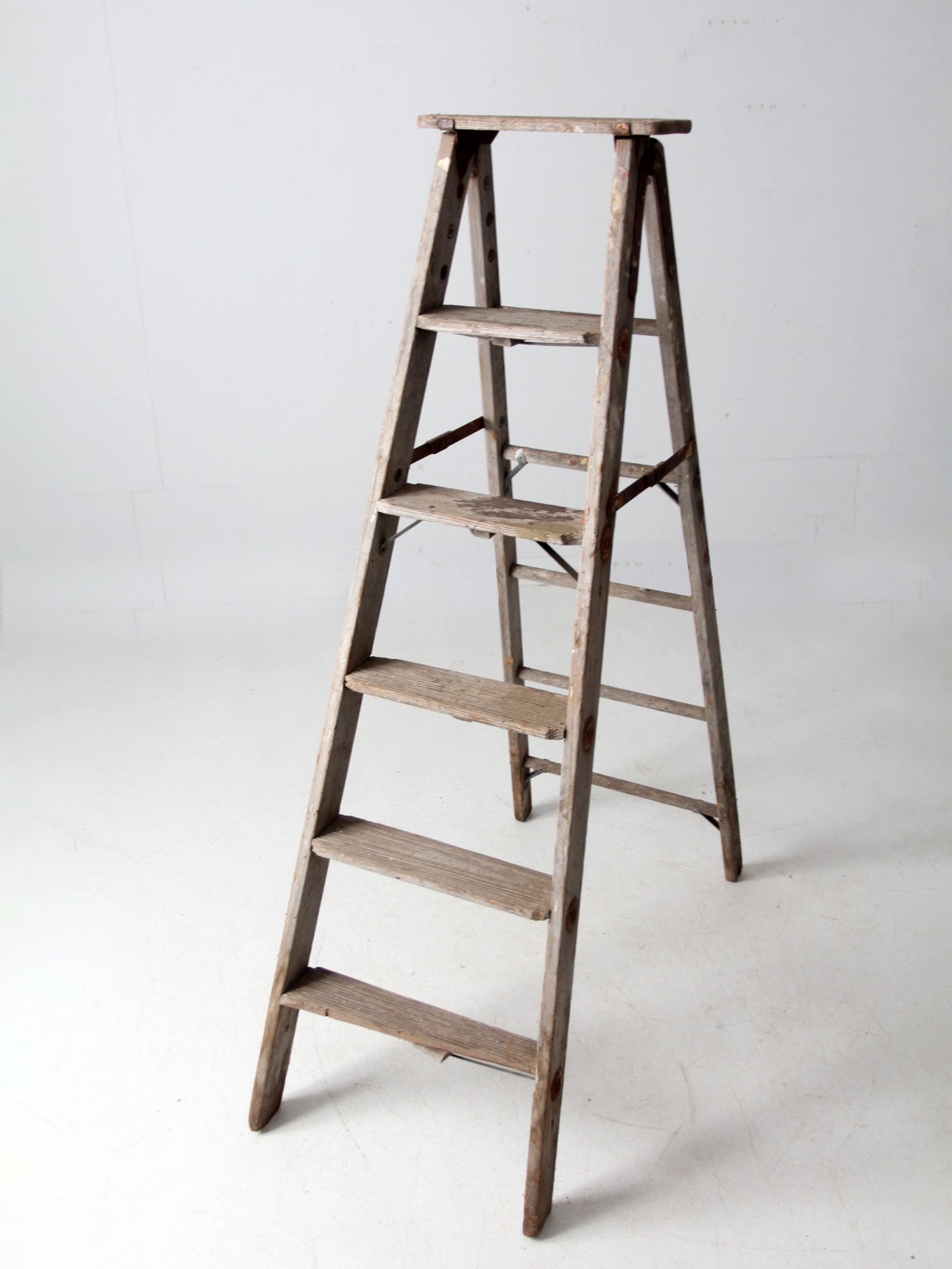 vintage wooden ladder with metal braces