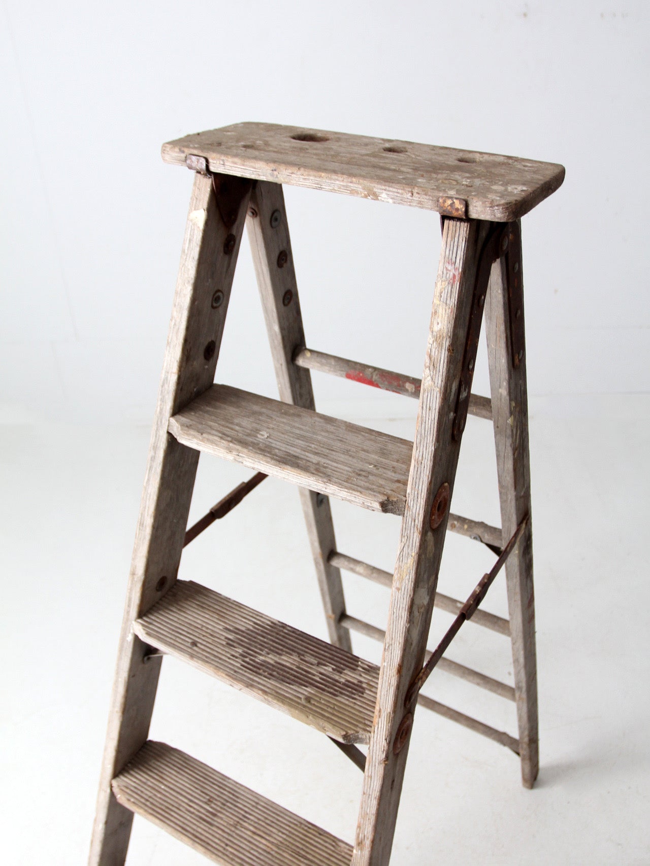 vintage wooden ladder with metal braces