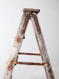 vintage wooden ladder with metal braces