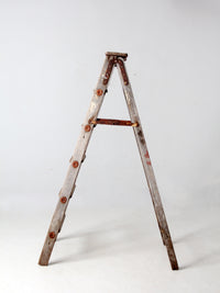 vintage wooden ladder with metal braces