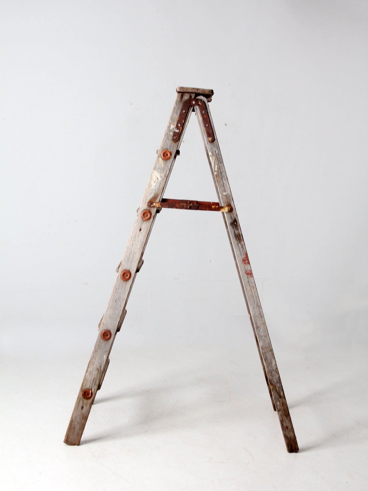 vintage wooden ladder with metal braces