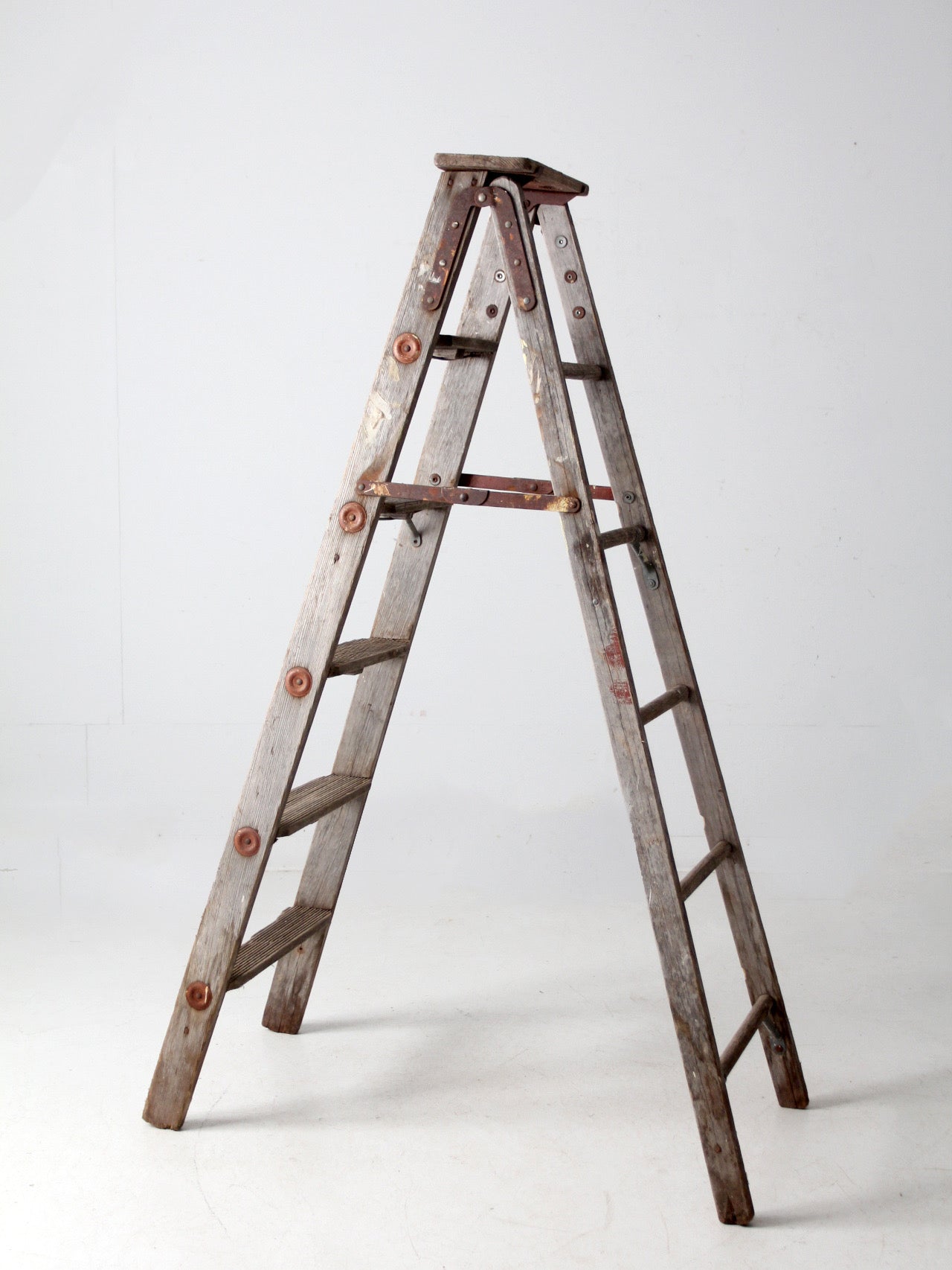 vintage wooden ladder with metal braces