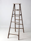 vintage wooden ladder with metal braces