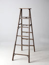 vintage wooden ladder with metal braces