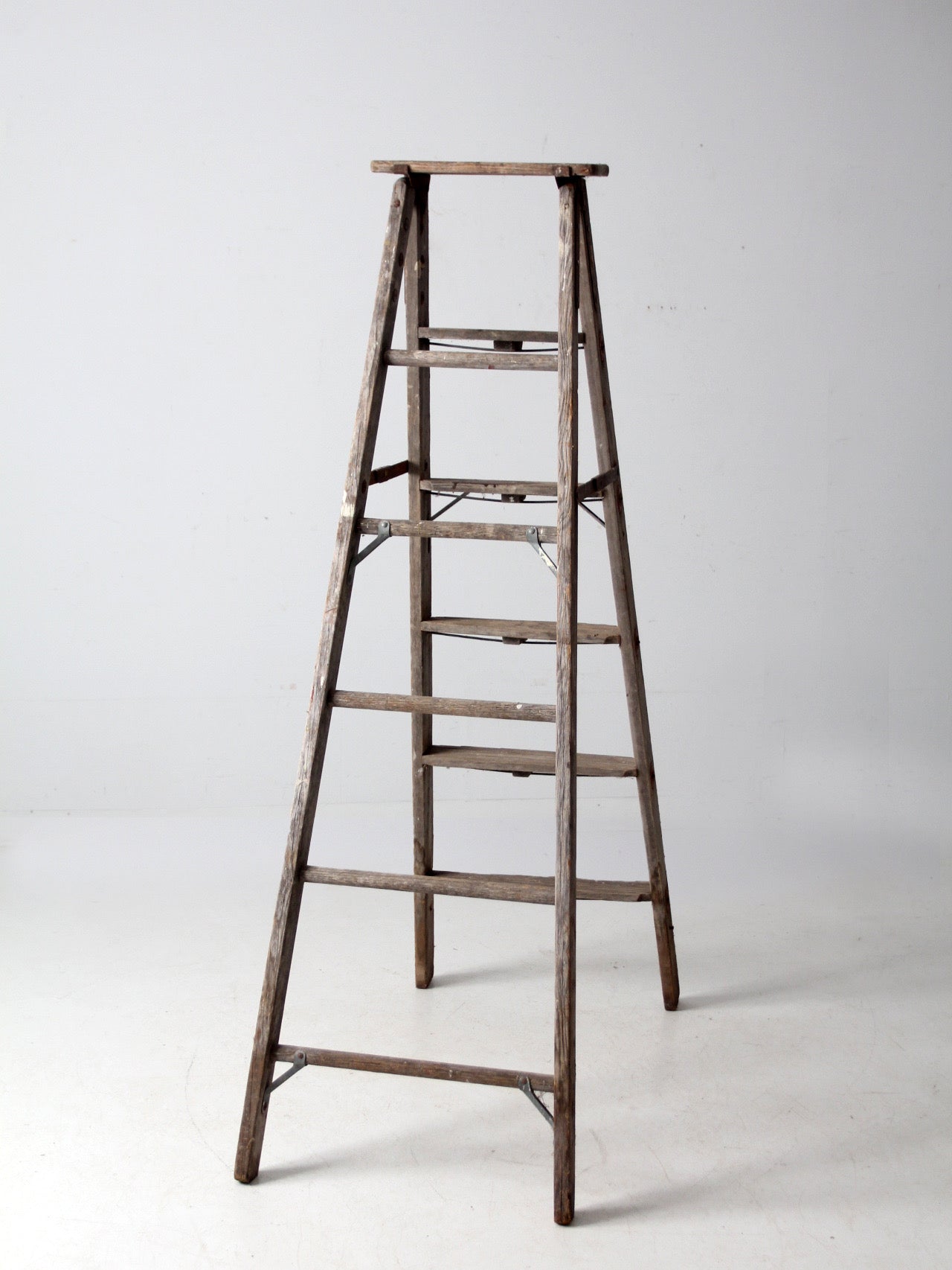 vintage wooden ladder with metal braces