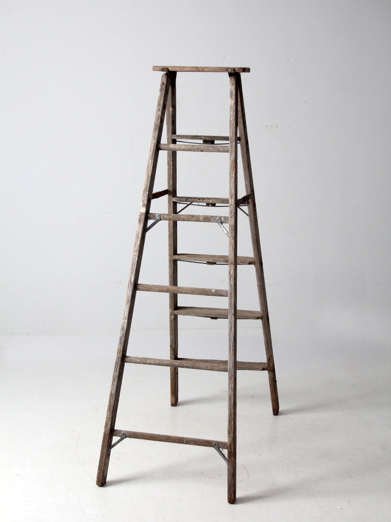 vintage wooden ladder with metal braces