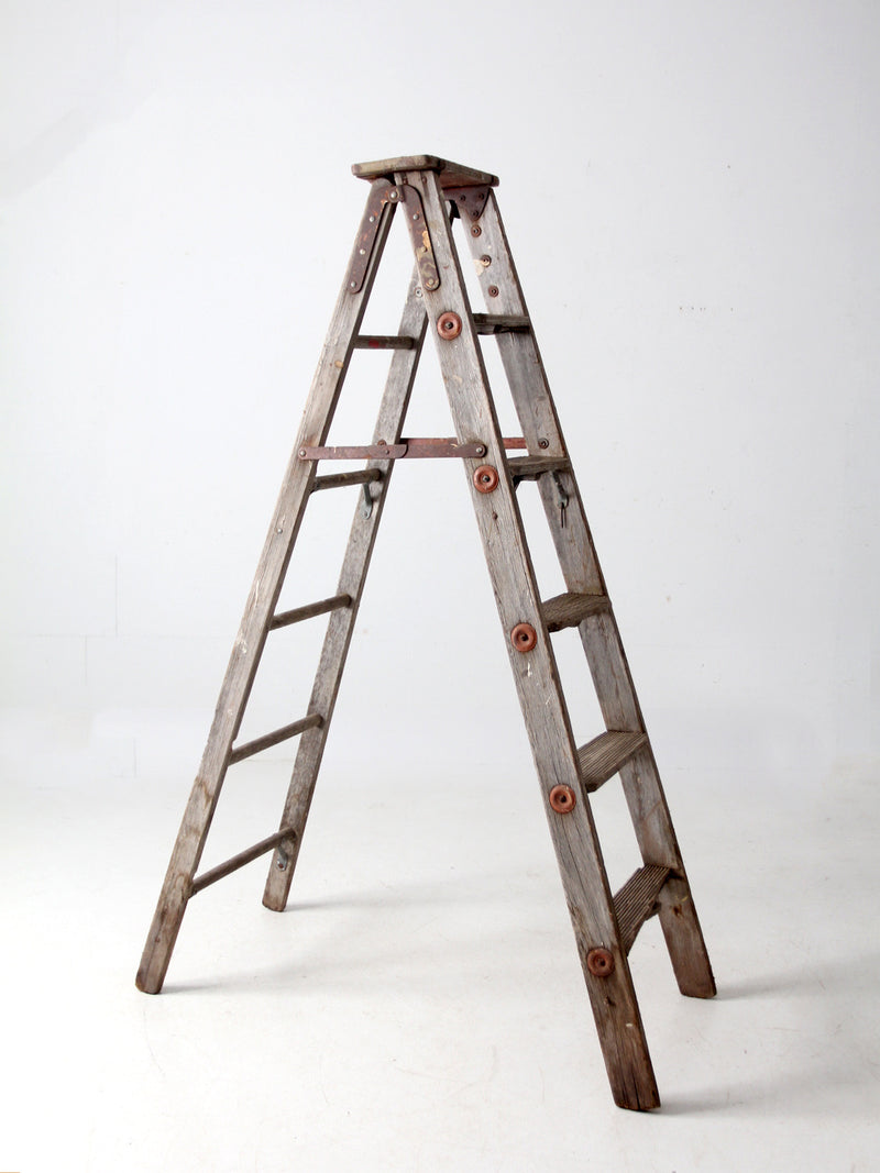 vintage wooden ladder with metal braces