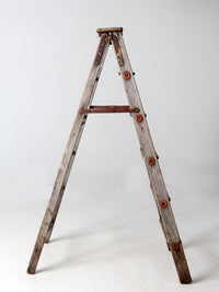 vintage wooden ladder with metal braces