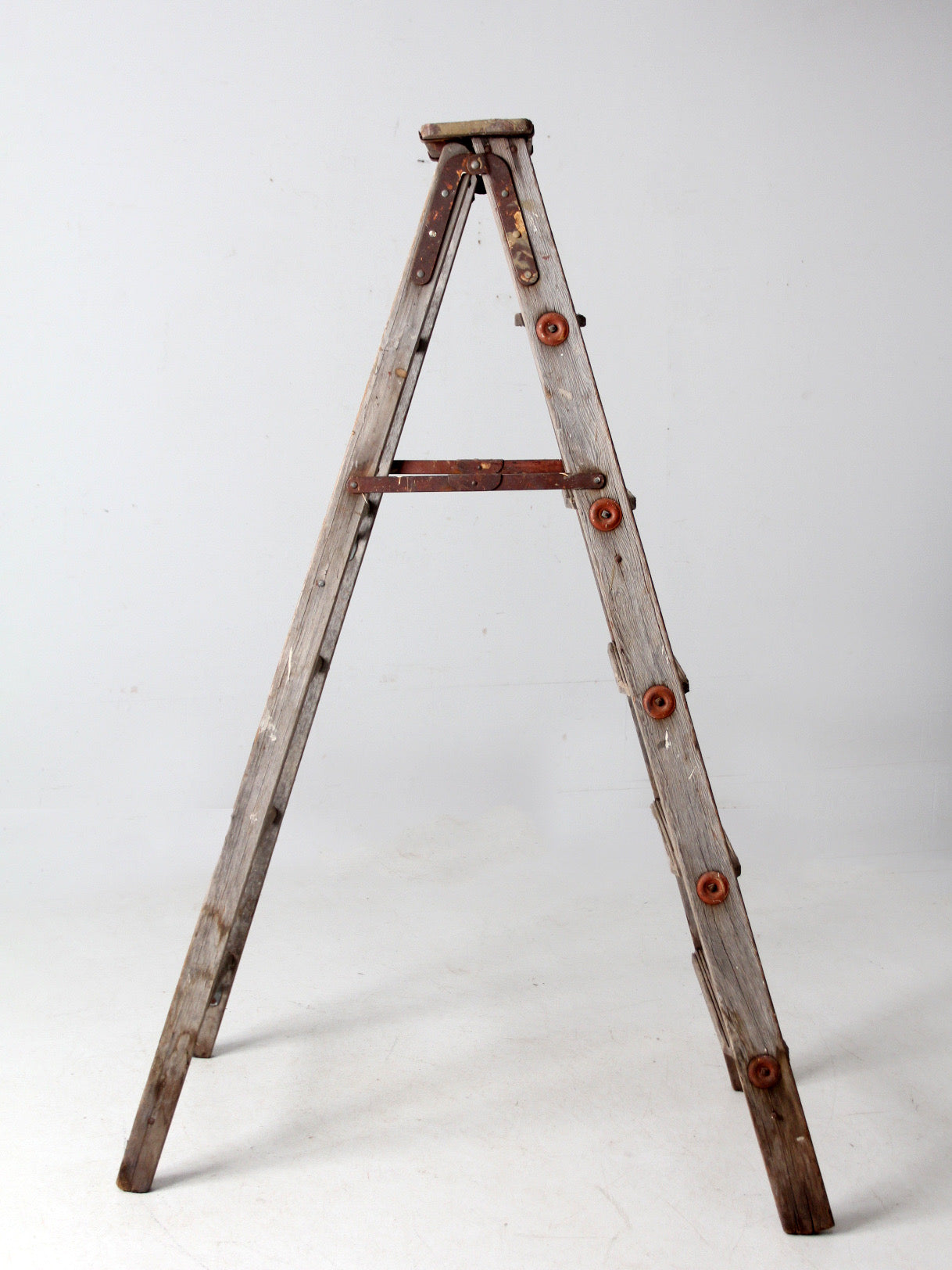 vintage wooden ladder with metal braces