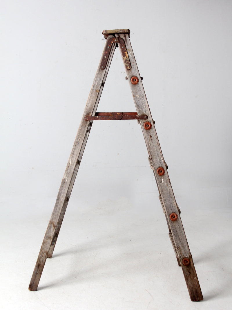 vintage wooden ladder with metal braces