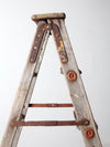 vintage wooden ladder with metal braces